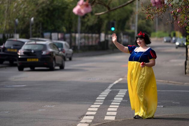 (200411) -- STOCKPORT, April 11, 2020 -- Rebecca Williamson, a girl dressed in Snow White costumes, cheers up people amid the COVID-19 pandemic in Stockport near Manchester, Britain, on April 10, 2020. Rebecca, one of those who dressed as comic books or fairytale characters, attempted to cheer up people in the public during the epidemic outbreak. (Photo by Xinhua) UK-STOCKPORT-COVID-19-SNOW WHITE JonxSuper 
