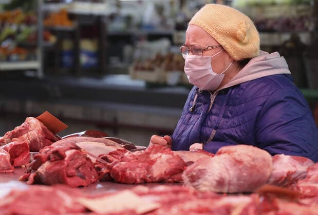 NOVOSIBIRSK, RUSSIA - APRIL 11, 2020: An elderly woman shopping for meat at the Oktyabrsky food market. Russian President Vladimir Putin has expanded non-working period till April 30, 2020 to prevent the spread of the novel coronavirus. Kirill Kukhmar TASS  TS0D5475