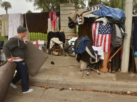 Homeless veterans socialize at an encampment, adjacent to the West Los Angeles VA Medical Center during the coronavirus pandemic in Los Angeles on Friday, April 10, 2020.  LAP2020041021 JIMxRUYMEN