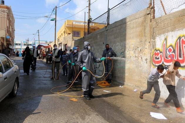 April 11, 2020, Dair Al Balah, Gaza Strip, Palestinian Territory: Palestinian workers spray disinfectant as a preventive measure amid fears of the spread of the coronavirus disease (COVID-19), in Dair Al Balah in the center of Gaza strip, on April 11, 2020 Dair Al Balah Palestinian Territory - ZUMAap3_ 20200411_zaf_ap3_065 Copyright: xAshrafxAmrax