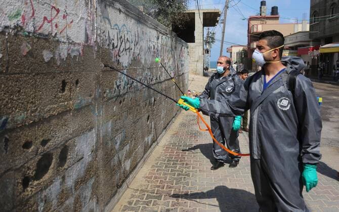 April 11, 2020, Dair Al Balah, Gaza Strip, Palestinian Territory: Palestinian workers spray disinfectant as a preventive measure amid fears of the spread of the coronavirus disease (COVID-19), in Dair Al Balah in the center of Gaza strip, on April 11, 2020 Dair Al Balah Palestinian Territory - ZUMAap3_ 20200411_zaf_ap3_079 Copyright: xAshrafxAmrax