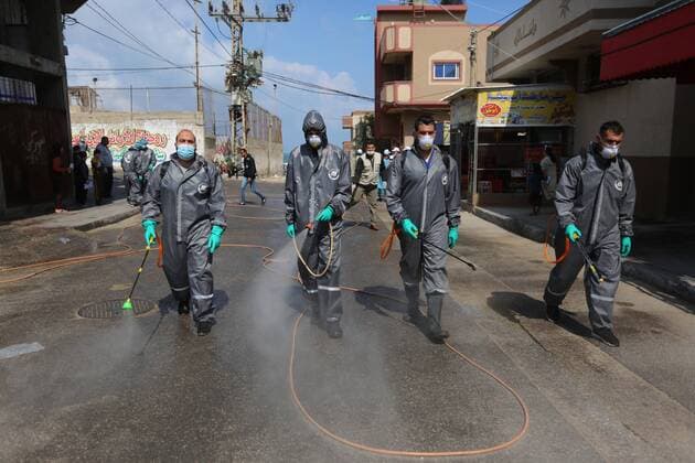 April 11, 2020, Dair Al Balah, Gaza Strip, Palestinian Territory: Palestinian workers spray disinfectant as a preventive measure amid fears of the spread of the coronavirus disease (COVID-19), in Dair Al Balah in the center of Gaza strip, on April 11, 2020 Dair Al Balah Palestinian Territory - ZUMAap3_ 20200411_zaf_ap3_082 Copyright: xAshrafxAmrax