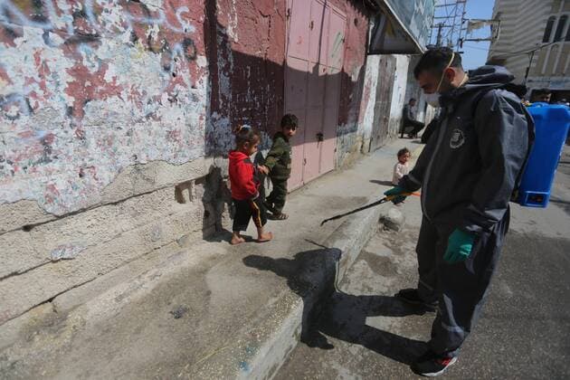 April 11, 2020, Dair Al Balah, Gaza Strip, Palestinian Territory: Palestinian workers spray disinfectant as a preventive measure amid fears of the spread of the coronavirus disease (COVID-19), in Dair Al Balah in the center of Gaza strip, on April 11, 2020 Dair Al Balah Palestinian Territory - ZUMAap3_ 20200411_zaf_ap3_085 Copyright: xAshrafxAmrax