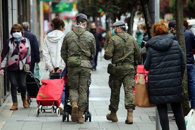 Spain: 29th day of alert status for CoVid-19 Gijon, SPAIN: Two soldiers help a girl with her purchases during the 29th day of the Spanish Alert State, in Gijon, Spain on April 11, 2020. Gijon Asturias Spain Copyright: AlbertoxBrevers