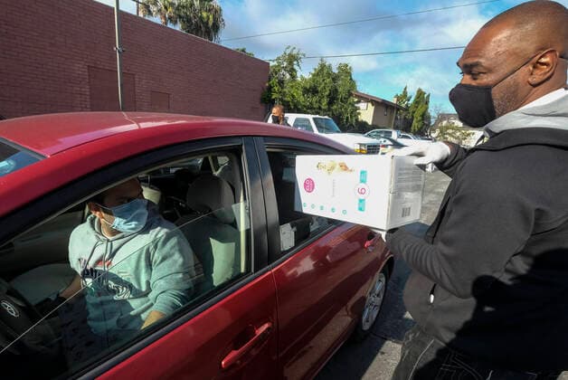 April 11, 2020, Los Angeles, California, U.S: A staff loads diapers into a vehicle during a drive thru grab-and-go distribution of diapers to assist families in need during the COVID-19 outbreak on Saturday April 11, 2020, in Los Angeles. Los Angeles U.S. - ZUMAc68_ 20200411_zaf_c68_004 Copyright: xRingoxChiux