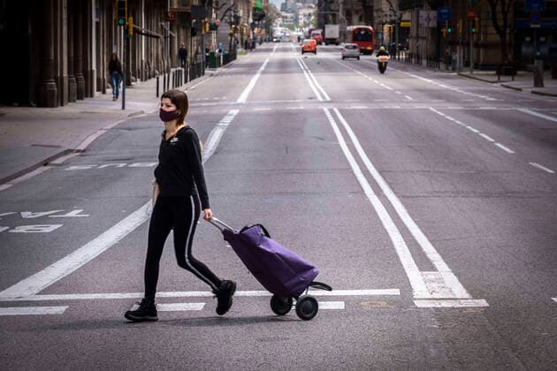 April 11, 2020, Barcelona, Catalonia, Spain: A woman wearing a sanitary mask as a preventive measure walks with a shopping cart during the Covid-19 contagion..Barcelona faces the 28th day of home confinement. The streets remain deserted except for main activities. Barcelona Spain - ZUMAs197 20200411_zaa_s197_038 Copyright: xPacoxFreirex