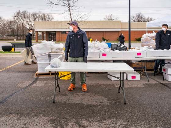 April 11, 2020, Des Moines, Iowa, U.S: JORDON ELWELL, owner and CEO of Midwest Foods, waits for a motorist during a food distribution in Des Moines. He used a plastic table to pass a ready to cook pasta meal to motorists as they drove past him. Most non-essential businesses in Iowa are closed until 30 April. Because of business closings causes by the Novel Coronavirus (SARS-CoV-2) pandemic, well over 100,000 Iowans filed first time claims for unemployment in the last three weeks, more than applied during the peak of the Great Recession of 2008. Local food banks have seen an unprecedented spike in people seeking nutritional assistance. Midwest Foods, a Des Moines based company and owner of Ginos Fine Italian Foods, gave away 1,000 complete dinners with sauce, noodles, salad, and dressing Saturday morning. People started lining up 3 hours b - ZUMAk94_ 20200411_zaf_k94_010 Copyright: xJackxKurtzx