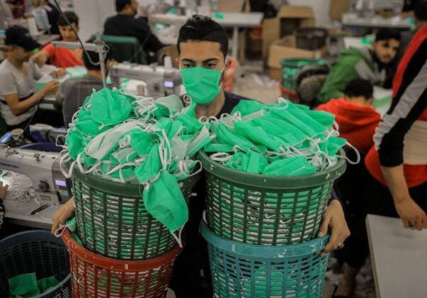 April 11, 2020, Gaza City, The Gaza Strip, Palestine: Palestinian workers at Gaza city make protective face masks to be exported and sold in US and Europe. Gaza City Palestine - ZUMAq100 20200411_zaa_q100_034 Copyright: xAbedxAlrahmanxAlkahloutx