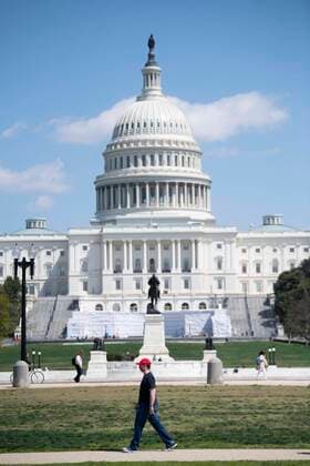 (200411) -- WASHINGTON, April 11, 2020 -- A man wearing a mask takes a walk near the U.S. Capitol building in Washington D.C., the United States, April 11, 2020. The total number of deaths due to COVID-19 in the United States topped 20,000 Saturday afternoon, according to data compiled by the Center for Systems Science and Engineering (CSSE) at Johns Hopkins University. ) U.S.-WASHINGTON D.C.-COVID-19-DEATH TOLL LiuxJie 