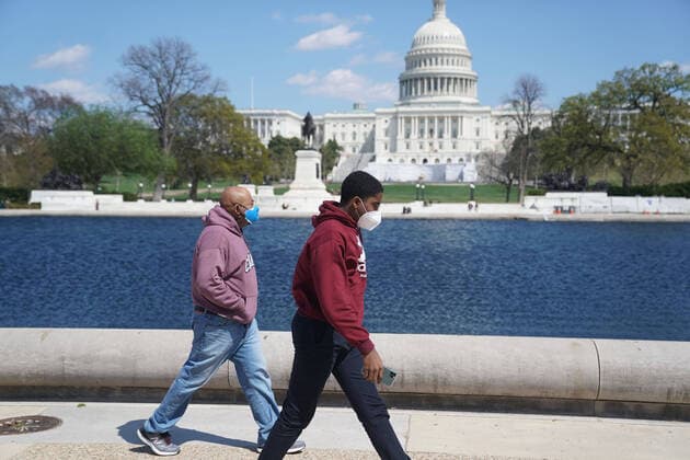 (200411) -- WASHINGTON, April 11, 2020 -- People wearing masks take a walk near the U.S. Capitol building in Washington D.C., the United States, April 11, 2020. The total number of deaths due to COVID-19 in the United States topped 20,000 Saturday afternoon, according to data compiled by the Center for Systems Science and Engineering (CSSE) at Johns Hopkins University. ) U.S.-WASHINGTON D.C.-COVID-19-DEATH TOLL LiuxJie 
