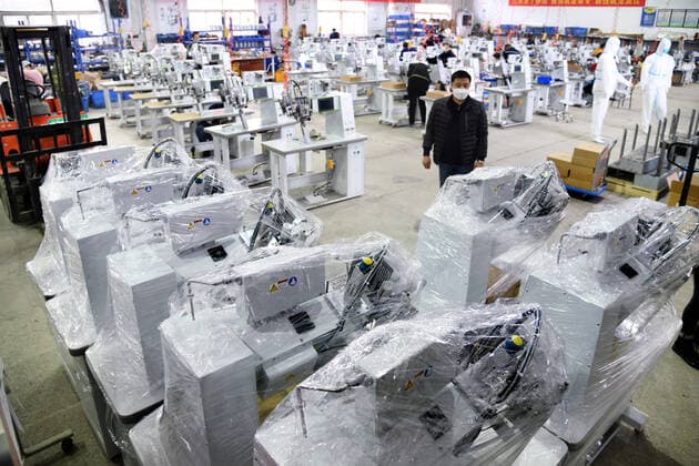 (200412) -- QINGDAO, April 12, 2020 -- Han Chuqi, head of the Nawon Machinery Co., Ltd., examines the seam sealing equipment for protective clothes which will be transported to South Korea at the workshop of the company in Jimo District of Qingdao, east China s Shandong Province, April 11, 2020. Since its resumption of production on Feb. 7, the South Korea-invested Nawon Machinery Co., Ltd. has been producing at full speed the seam sealing equipment for protective clothes, a necessary but not mass produced equipment which has been in short supply due to the worldwide spread of the COVID-19 pandemic. ) CHINA-QINGDAO-COVID-19-SOUTH KOREAN COMPANY-SEAM SEALING EQUIPMENT-PRODUCTION (CN) LixZiheng