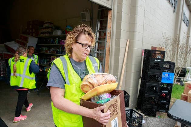 April 11, 2020, Ellettsville, Indiana, United States: Volunteers at Pantry 279 distribute food to area residents experiencing food insecurity during the COVID-19 Coronavirus emergency... The pantry nearly ran out of food after more than 600 people, from 179 different families, came seeking food last Wednesday, but last minute trips to local grocery stores, some people dropping off food donations, and a last minute shipment of produce helped keep the pantry in stock. Ellettsville United States - ZUMAs197 20200411_zaa_s197_164 Copyright: xJeremyxHoganx