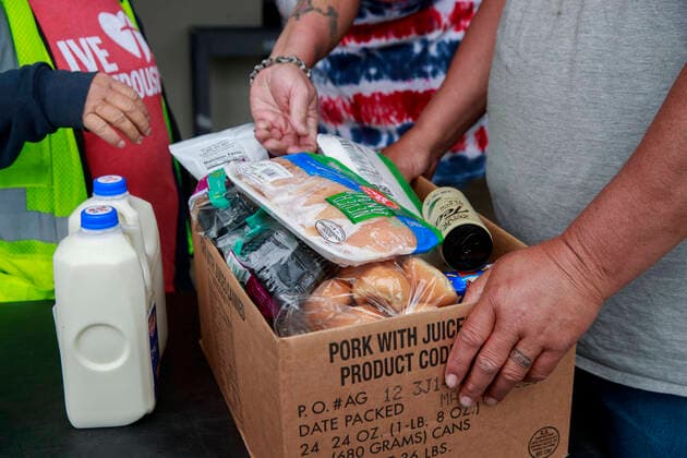 April 11, 2020, Ellettsville, Indiana, United States: Volunteers at Pantry 279 distribute food to area residents experiencing food insecurity during the COVID-19 Coronavirus emergency... The pantry nearly ran out of food after more than 600 people, from 179 different families, came seeking food last Wednesday, but last minute trips to local grocery stores, some people dropping off food donations, and a last minute shipment of produce helped keep the pantry in stock. Ellettsville United States - ZUMAs197 20200411_zaa_s197_167 Copyright: xJeremyxHoganx