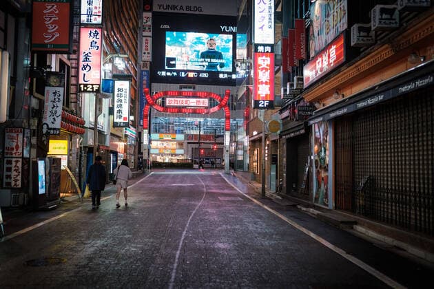 A couple walks in the empty main street in Kabukicho (Shinjuku s red light district) in Tokyo, Japan, 11 April 2020. Japanese Prime Minister Shinzo Abe declared a state of emergency for at least one month amid an increase of coronavirus and COVID-19 infection cases. April 11, 2020  (125267584)