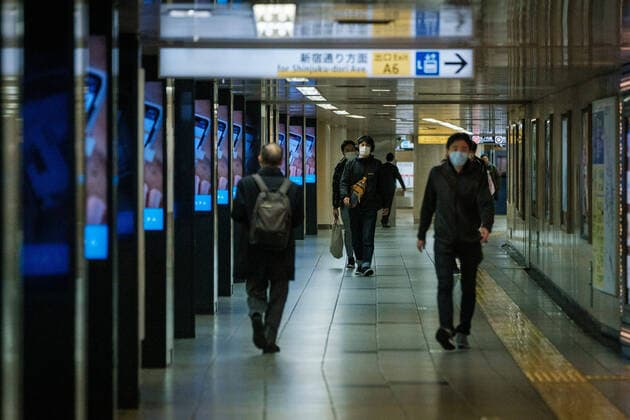 Commuters wearing mask walk inside the Shinjuku s station in Tokyo, Japan, 11 April 2020. Japanese Prime Minister Shinzo Abe declared a state of emergency for at least one month amid an increase of coronavirus and COVID-19 infection cases. April 11, 2020  (125267590)
