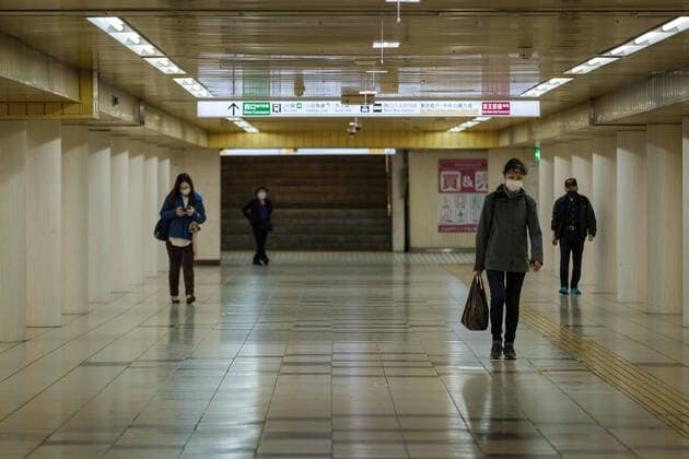 Commuters wearing mask walk inside the Shinjuku s station in Tokyo, Japan, 11 April 2020. Japanese Prime Minister Shinzo Abe declared a state of emergency for at least one month amid an increase of coronavirus and COVID-19 infection cases. April 11, 2020  (125267604)