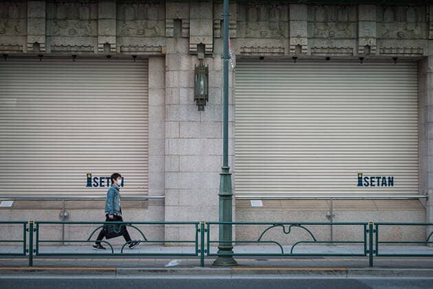 A man wearing a mask walks past by a closed shop in Shinjuku East area in Tokyo, Japan, 11 April 2020. Japanese Prime Minister Shinzo Abe declared a state of emergency for at least one month amid an increase of coronavirus and COVID-19 infection cases. April 11, 2020  (125267607)