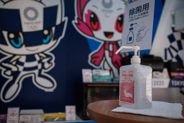 A hydro alcoholic sanitizer is displayed with olympic mascot in a shop entrance in Tokyo, Japan, 11 April 2020. Japanese Prime Minister Shinzo Abe declared a state of emergency for at least one month amid an increase of coronavirus and COVID-19 infection cases. April 11, 2020  (125267668)