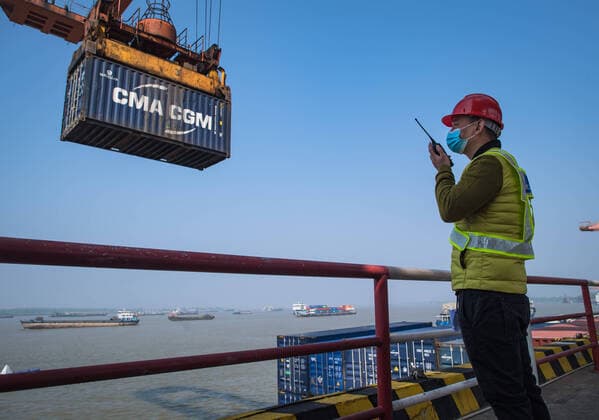 (200412) -- WUHAN, April 12, 2020 -- A staff member speaks to an intercom at the Yangluo Port in Wuhan, central China s Hubei Province, April 12, 2020. Wuhan, the megacity in central China, lifted outbound travel restrictions from April 8 after almost 11 weeks of lockdown to stem the spread of COVID-19. The cargos piled up at ports due to the COVID-19 pandemic have also been shipping away since the water ports in Wuhan resumed operation. ) CHINA-HUBEI-WUHAN-SHIPPING (CN) XiaoxYijiu 