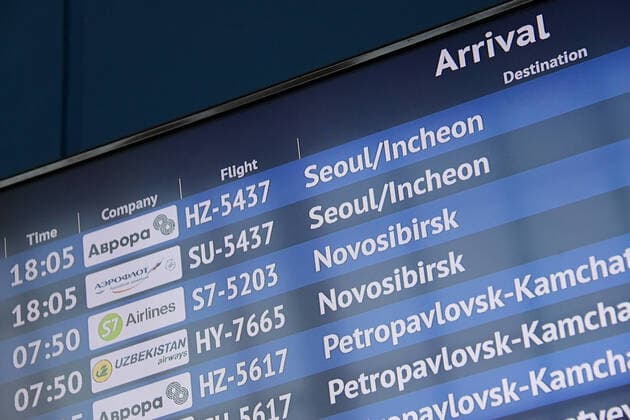 VLADIVOSTOK, RUSSIA - APRIL 12, 2020: An arrivals schedule at Vladivostok International Airport where a plane of the Aurora Russian Far East air carrier, subsidiary of Aeroflot - Russian Airlines, carrying Russian citizens from Seoul has landed. Russia has suspended all international flights from March 27, 2020 due to the COVID-19 infection threat. Airlines are allowed to fly to other countries to evacuate Russian citizens. Yuri Smityuk TASS  TS0D567E