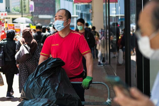 April 12, 2020, Hong Kong, China: People wear surgical face mask on the street. Corona Virus (Covid19) cases in Hong Kong have reached over 1,000 on Saturday as authorities urged the public to stay at home during the long Easter weekend. Hong Kong China - ZUMAt141 20200412_zap_t141_005 Copyright: xKeithxTsujix