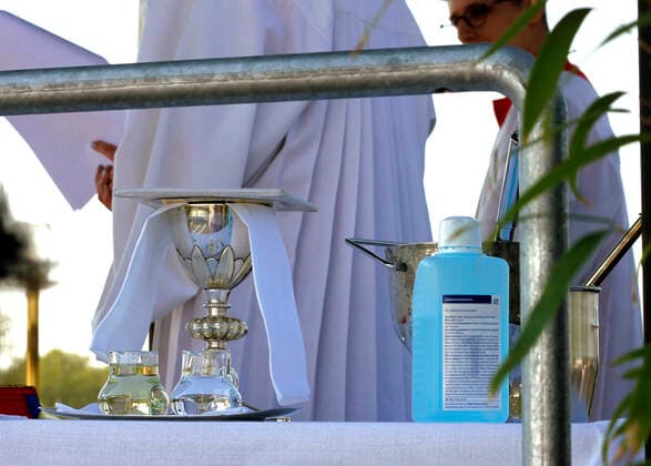 12 04 2020, Catholic Easter Mass at the drive-in cinema in Düsseldorf, table with gifts, holy water and hand disinfectant 12 04 2020, Catholic Easter Mass at the drive-in cinema in Düsseldorf 12 04 2020, Catholic Easter Mass at the drive-in cinema in Düsseldorf