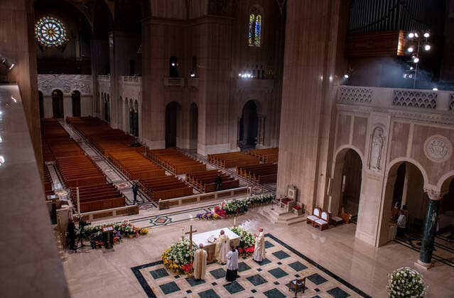 Archbishop of Washington Wilton Daniel Gregory (C) holds Easter mass to a virtual congregation at the Basilica of the National Shrine of the Immaculate Conception, in Washington, DC, Sunday, April 12, 2020. The Archdiocese of Washington DC closed the Basilica to the public and live-streamed the mass due to the coronavirus COVID-19 pandemic.  WAP20200412323 KEVINxDIETSCH