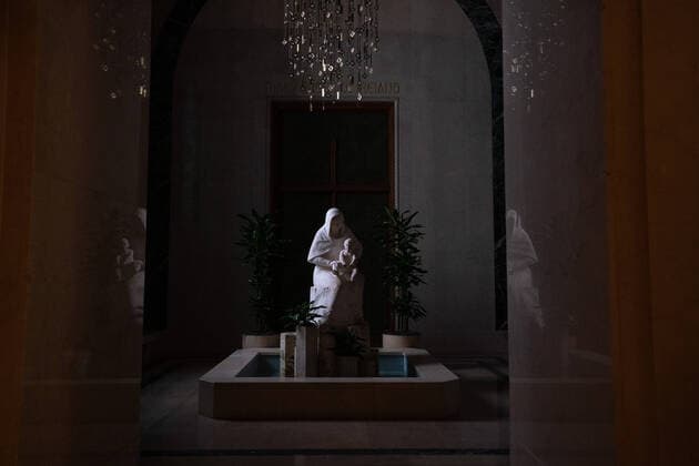 A statue of Mary Mother of God is seen in a darken hallway at the Basilica of the National Shrine of the Immaculate Conception as the Basilica holds a live-stream Easter mass, in Washington, DC, Sunday, April 12, 2020. The Archdiocese of Washington DC closed the Basilica to the public and live-streamed the mass due to the coronavirus COVID-19 pandemic.  WAP20200412331 KEVINxDIETSCH