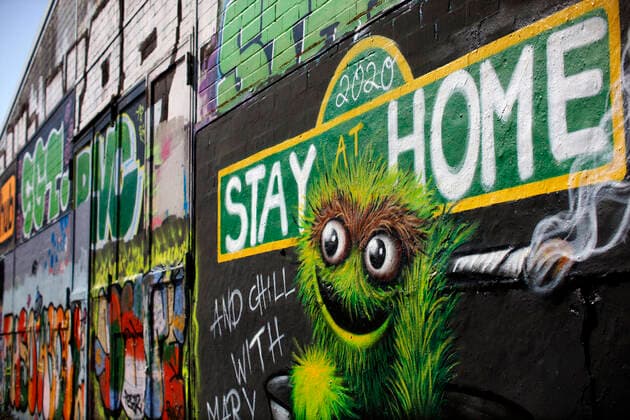 Duesseldorf, Germany, 12 04 2020 The graffiti mural on the outside wall of a warehouse in Duesseldorf Moersenbroich uses the slogan Stay at Home with the recommendation to relax there with a joint Chill with Mary Jane