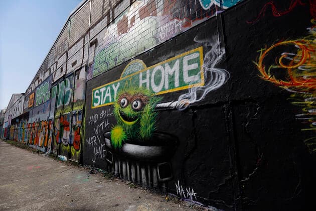 Duesseldorf, Germany, 12 04 2020 The graffiti mural on the outside wall of a warehouse in Duesseldorf Moersenbroich uses the slogan Stay at Home with the recommendation to relax there with a joint Chill with Mary Jane