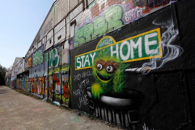 Duesseldorf, Germany, 12 04 2020 The graffiti mural on the outside wall of a warehouse in Duesseldorf Moersenbroich uses the slogan Stay at Home with the recommendation to relax there with a joint Chill with Mary Jane