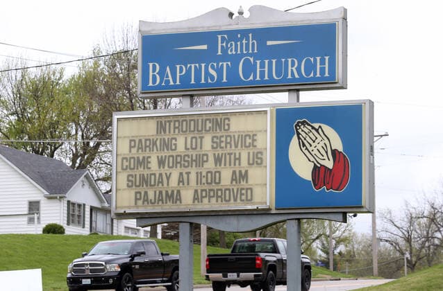 Drivers begin to arrive for Easter Services at the Faith Baptist Church in St. Charles, Missouri on Sunday, April 12, 2020. The church held a parking lot service, keeping parishioners in their cars, listening to music and a sermon, honking their horns for approval.  SLP2020041211 BILLxGREENBLATT