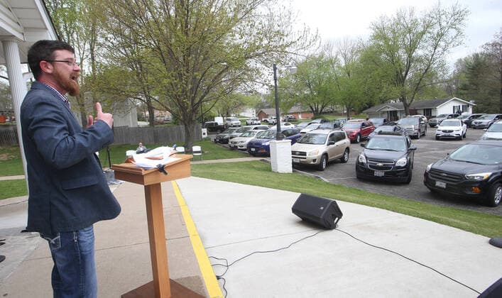 Pastor Justin Arender delivers his Easter Service to the faithful at the Faith Baptist Church in St. Charles, Missouri on Sunday, April 12, 2020. The church held a parking lot service, keeping parishioners in their cars, listening to music and a sermon, honking their horns for approval.  SLP2020041219 BILLxGREENBLATT