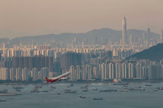 April 12, 2020, Hong Kong, China: An aircraft takes off at the Hong Kong International Airport pass the background of Shenzhen and empty vessel. Airlines across the globe have cancelled flights, postponed or adjusted their services in response to the coronavirus outbreak. Hong Kong China - ZUMA 20200412_mda_j323_039 Copyright: xMayxJamesx