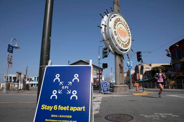 (200413) --SAN FRANCISCO, April 13, 2020 -- Photo taken on April 12, 2020 shows a board reminding people to keep social distancing at the Fisherman s Wharf amid COVID-19 outbreak in San Francisco, the United States. (Photo by Xinhua) U.S.-SAN FRANCISCO-COVID-19 LixJianguo 