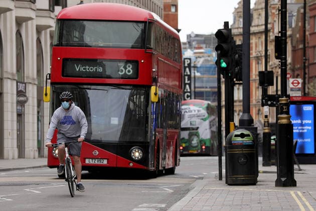 (200413) -- LONDON, April 13, 2020 (Xinhua) -- A man wearing a mask cycles down Shaftesbury Avenue in London, Britain, April 13, 2020. The death toll of those hospitalized in Britain who tested positive for the novel coronavirus reached 10,612 as of Saturday afternoon, the Department of Health and Social Care said Sunday. (Photo by Tim Ireland Xinhua) BRITAIN-LONDON-COVID-19-DEATH TOLL 