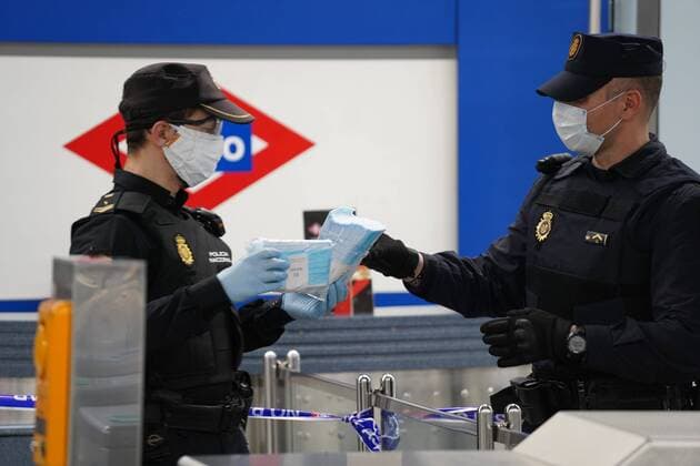 A police officer gives out free protective face masks during the lockdown amid the coronavirus disease COVID 19 outbreak in Madrid, Spain, April 13, 2020 Cordon Press