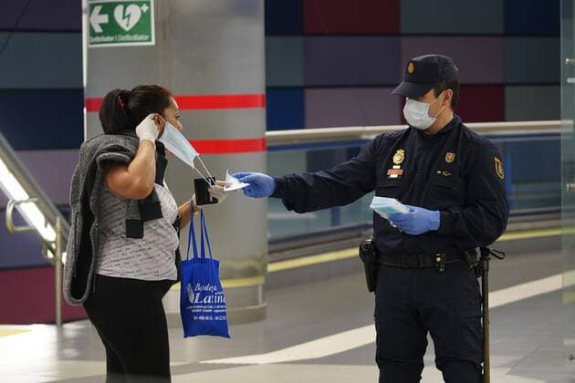 A police officer gives out free protective face masks during the lockdown amid the coronavirus disease COVID 19 outbreak in Madrid, Spain, April 13, 2020 Cordon Press