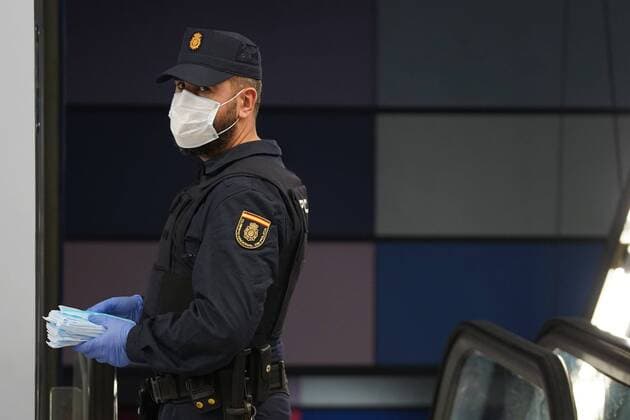 A police officer gives out free protective face masks during the lockdown amid the coronavirus disease COVID 19 outbreak in Madrid, Spain, April 13, 2020 Cordon Press