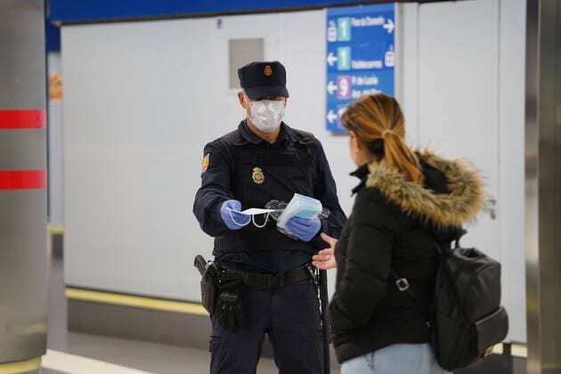 A police officer gives out free protective face masks during the lockdown amid the coronavirus disease COVID 19 outbreak in Madrid, Spain, April 13, 2020 Cordon Press