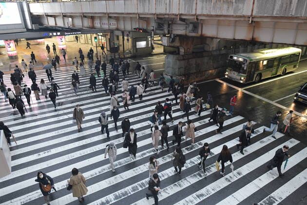OSAKA, JAPAN - APRIL 13: Commuters wearing mask head home near JR Osaka Station on Monday, April 13, 2020, amid the spread of the new coronavirus. Japanese Prime Minister Shinzo Abe declared a state of emergency last Tuesday for Tokyo and six other prefectures to ramp up defenses against the spread of the coronavirus. (Photo: Richard Atrero de Guzman AFLO)  (125303406)