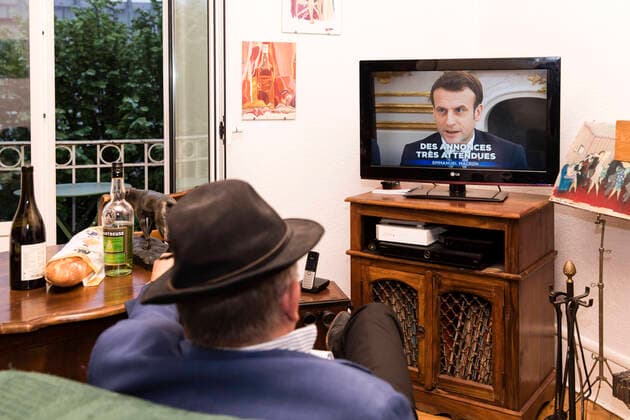 Chambery, France April 13, 2020 - A A confined French man in watching on television the speech of the French President Emmanuel Macron concerning the COVID19 health crisis ALLOCUTION, MACRON, PRESIDENT DE LA REPUBLIQUE, DISCOURS, COVID19, CRISE SANITAIRE, CONFINEMENT, SANTE, CORONAVIRUS, POLITIQUE Copyright: xVincentxIsorex