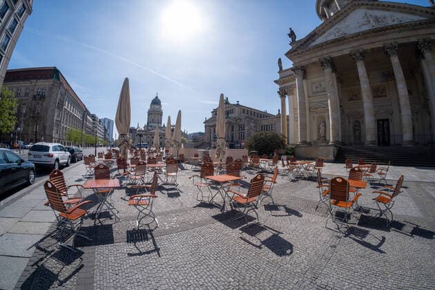 Empty tables and chairs of a café at Gendarmenmarkt in Berlin in the best, sunny spring weather Coronakrise Empty seats