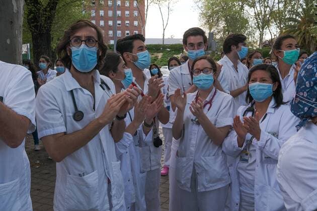 Medical staff from the Fundacion Jimenez Diaz Hospital gestures as neighbours applaud from their balconies in support of healthcare workers, during the coronavirus disease COVID 19 outbreak in Madrid, Spain April 13, 2020 Cordon Press