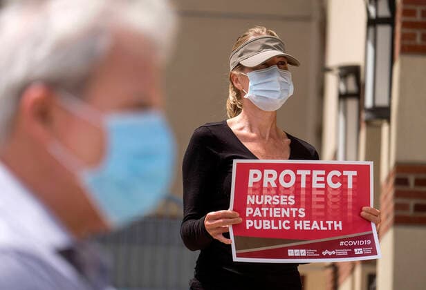 April 13, 2020, Los Angeles, California, U.S: A nurse joins other nurses and healthcare workers in a protest for the lack of personal protective equipment at UCLA Medical Center in Santa Monica, California, Monday April 13, 2020. Los Angeles U.S. - ZUMAc68_ 20200413_zaf_c68_001 Copyright: xRingoxChiux