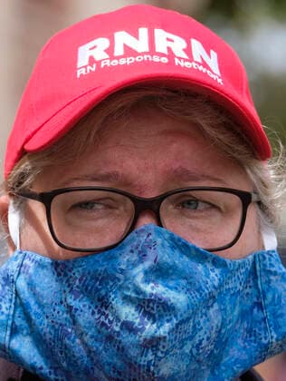 April 13, 2020, Los Angeles, California, U.S: A nurse joins other nurses and healthcare workers in a protest for the lack of personal protective equipment at UCLA Medical Center in Santa Monica, California, Monday April 13, 2020. Los Angeles U.S. - ZUMAc68_ 20200413_zaf_c68_014 Copyright: xRingoxChiux