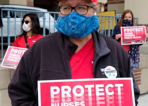 April 13, 2020, Los Angeles, California, U.S: A nurse joins other nurses and healthcare workers in a protest for the lack of personal protective equipment at UCLA Medical Center in Santa Monica, California, Monday April 13, 2020. Los Angeles U.S. - ZUMAc68_ 20200413_zaf_c68_018 Copyright: xRingoxChiux