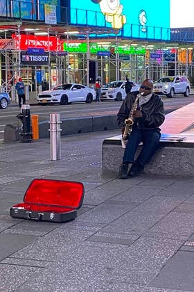 NEW YORK, NY- APRIL 13: Street Musician Playing Sax in Times Square at Night During the Coronavirus Pandemic in April 13, 2020 in New York City. Copyright: xRainmakerxPhotos MediaPunchx