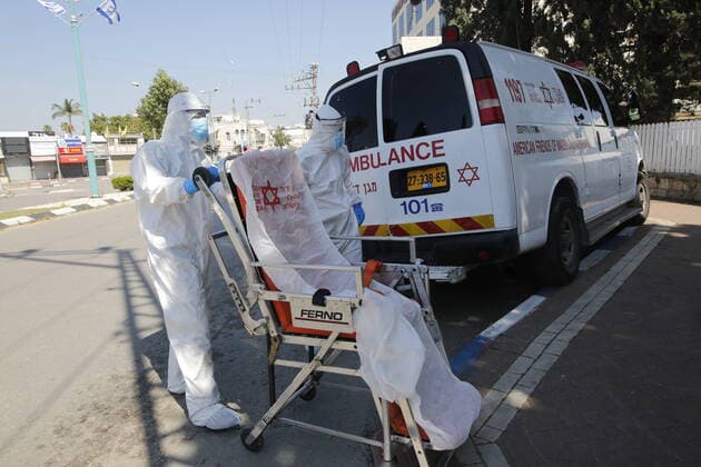(200414) -- RAMLA, April 14, 2020 (Xinhua) -- Medical workers wearing masks from the Israeli Magen David Adom national emergency service work amid COVID-19 pandemic in the central Israeli city of Ramla on April 13, 2020. The number of COVID-19 cases has risen to 11,586 in Israel after 441 new ones were added on Monday, the Israeli health ministry said. (Photo by Gil Cohen Magen Xinhua) MIDEAST-RAMLA-COVID-19 