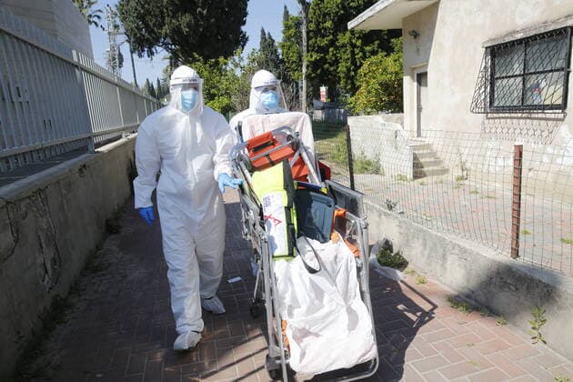 (200414) -- RAMLA, April 14, 2020 (Xinhua) -- Medical workers wearing masks from the Israeli Magen David Adom national emergency service work amid COVID-19 pandemic in the central Israeli city of Ramla on April 13, 2020. The number of COVID-19 cases has risen to 11,586 in Israel after 441 new ones were added on Monday, the Israeli health ministry said. (Photo by Gil Cohen Magen Xinhua) MIDEAST-RAMLA-COVID-19 
